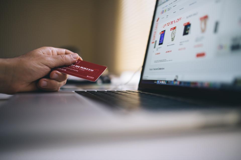 Online-Einkauf mit Kreditkarte am Laptop zum Thema Social Commerce