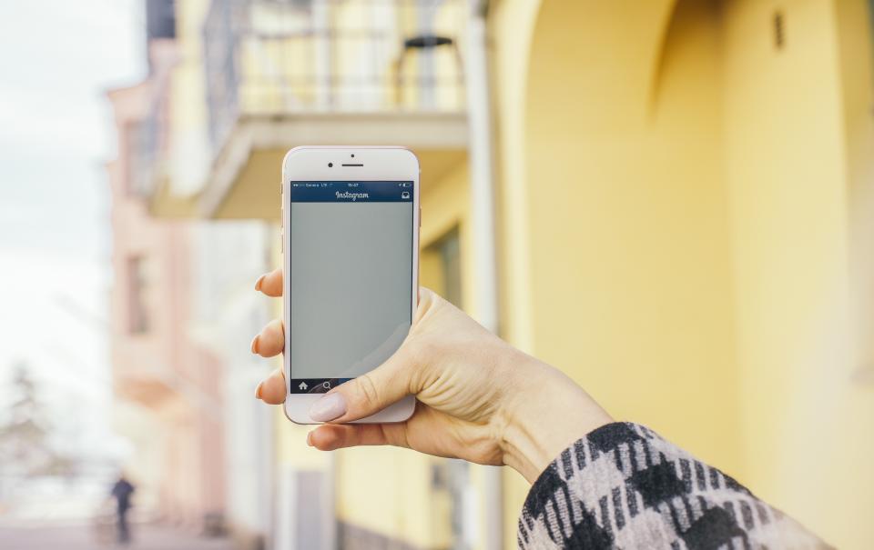 Hand hält Smartphone mit Social-Media-App