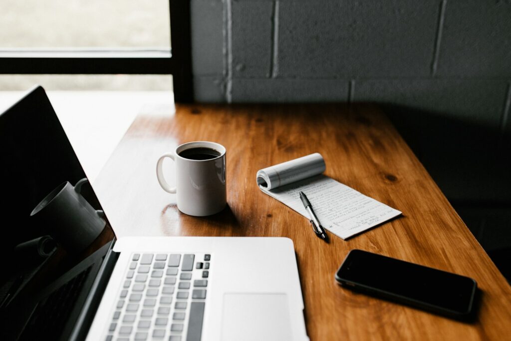 Verlassener Schreibtisch mit Laptop und Kaffeetasse als Symbol für Quiet Quitting
